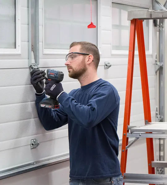 Austin's Affordable Garage Doors technician repairing a garage door